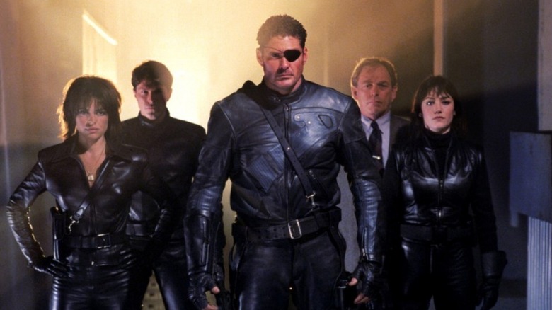 Val, Nick Fury, and Kate standing with men (1998)