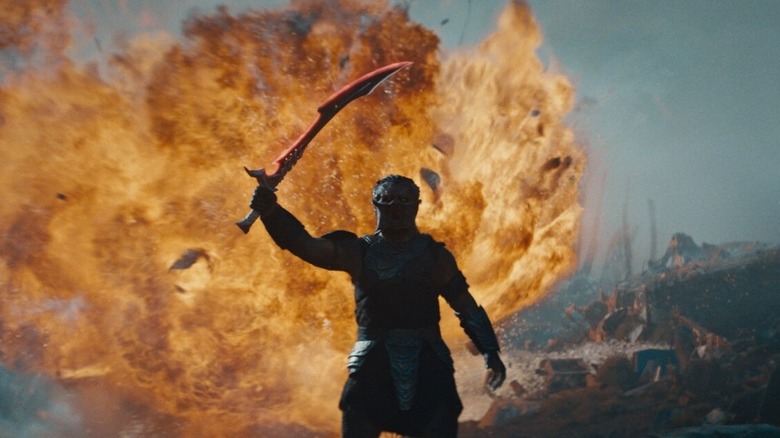 Dimitrius Schuster-Koloamatangi's Dek holding his sword in Predator: Badlands