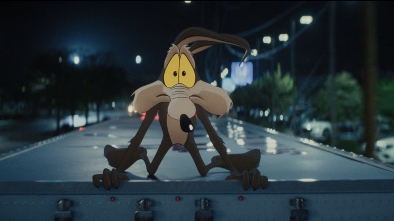 Wile E. Coyote looking concerned atop a truck in Coyote vs. Acme (2026)