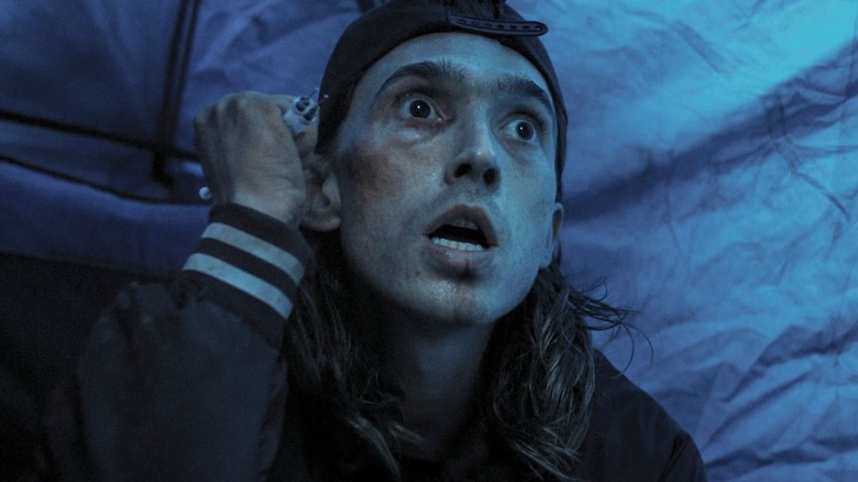 James clutching a weapon in Weapons (2025)