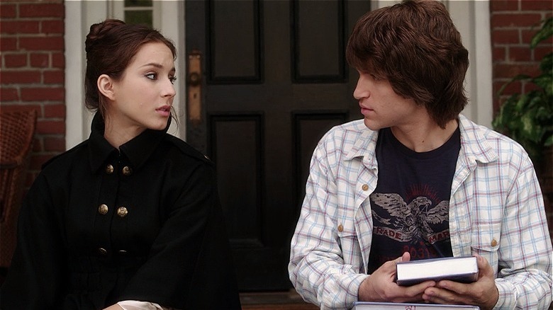Toby and Spencer gazing at each other while sitting on the porch