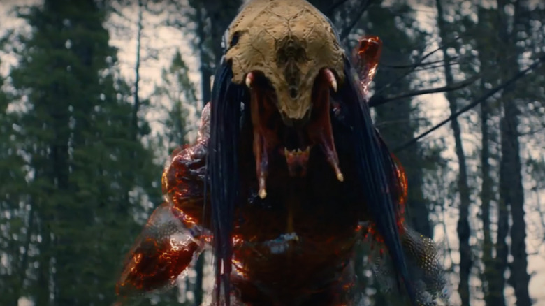 Predator in Prey yelling with mask on 