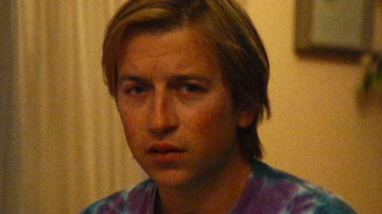 Dan Plum staring into the camera, unsettled, in "Primetime" (2026)