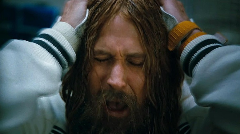 A close up of a distressed Grace with long hair in Project Hail Mary