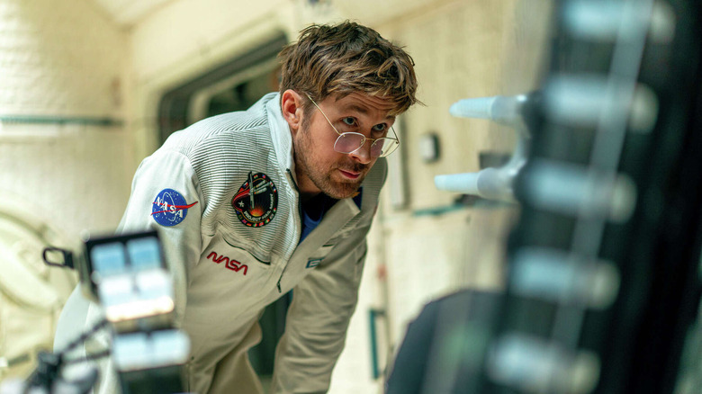 Ryland in the spaceship looking at something in Project Hail Mary