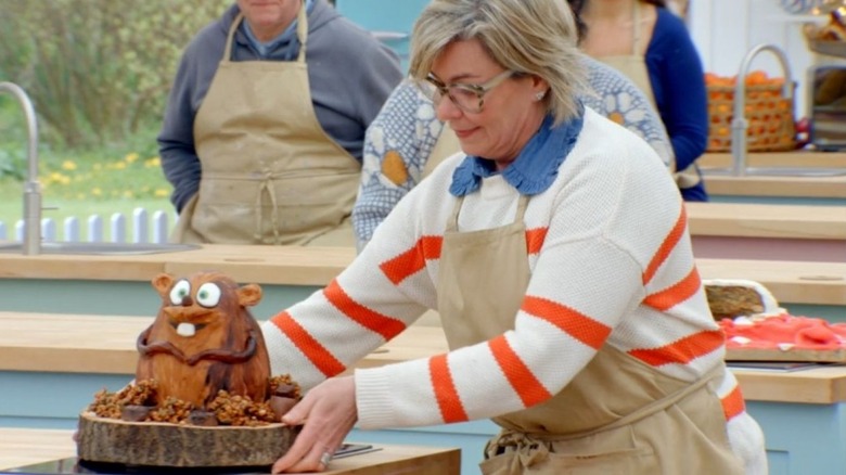 Contestant Nicky Laceby picks up her beaver cake in The Great British Bake Off