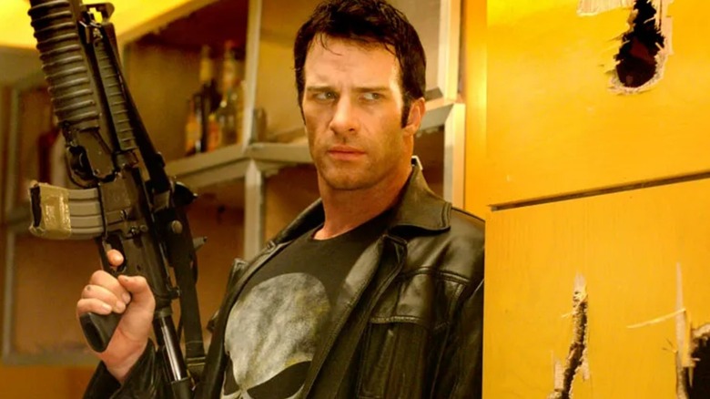 Frank Castle stands at a wall with a gun raised in "The Punisher" (2004)