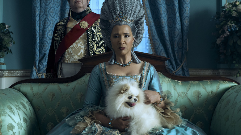 Older Queen Charlotte holding dog
