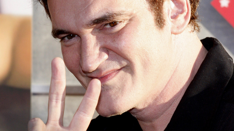 Quentin Tarantino giving peace sign