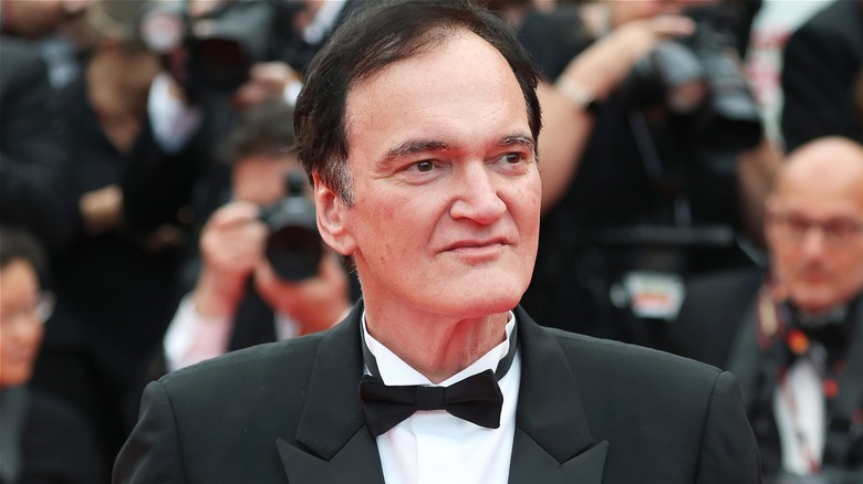 Quentin Tarantino walking the red carpet at a premiere