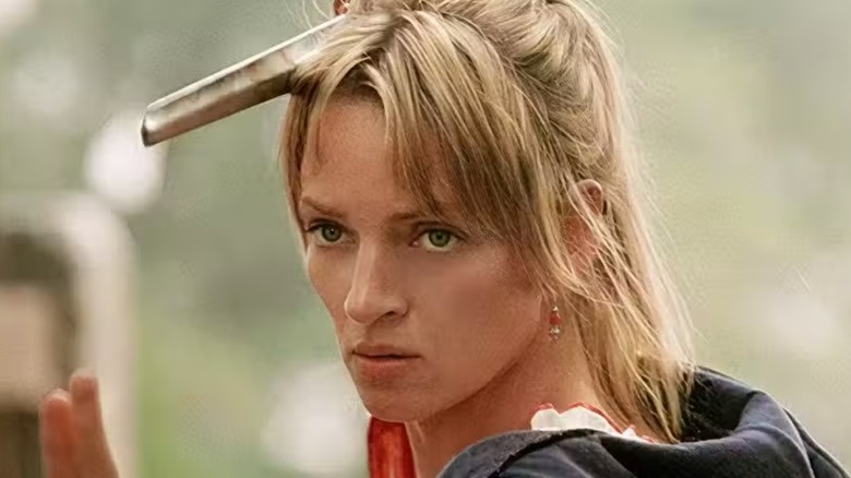Beatrix, The Bride, poses with a practice sword in Kill Bill: Volume 1 (2003)