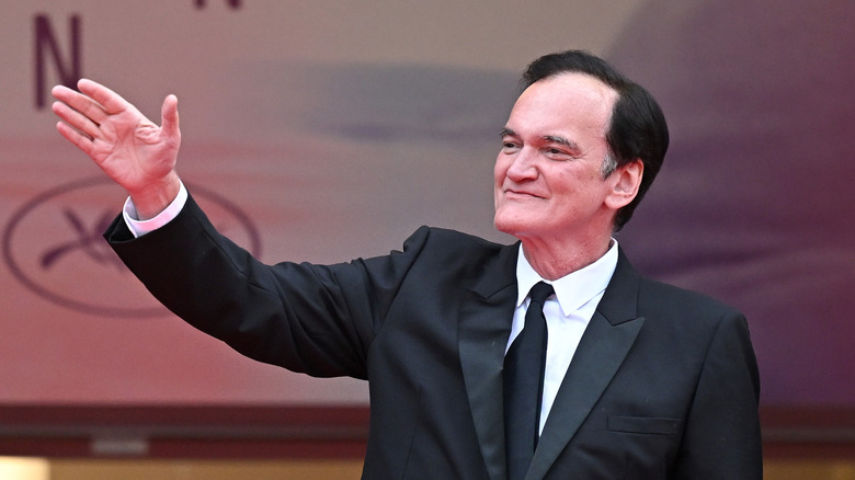 Quentin Tarantino waving at the Cannes Film Festival