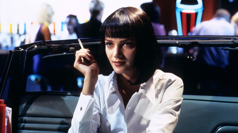Mia Wallace sitting in her car booth smoking a cigarette in Pulp Fiction