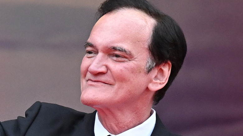 Quentin Tarantino waving at the Cannes Film Festival