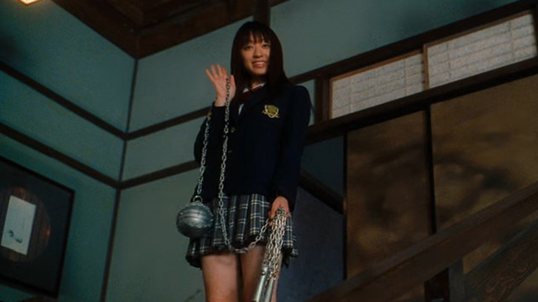 Gogo Yubari smiling and holding her mace weapon in 