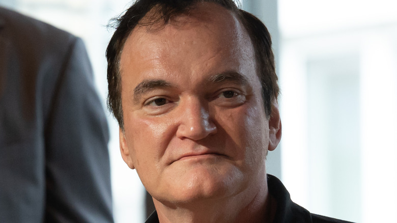 Tarantino looking serious and wearing a black shirt