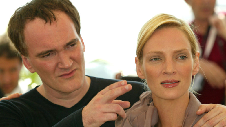 Quentin Tarantino pointing something out to Uma Thurman