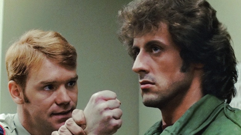 Rambo holding Deputy Mitch by the wrist in First Blood (1982)