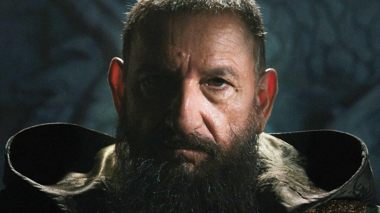 Trevor Slattery as the Mandarin sitting in shadows