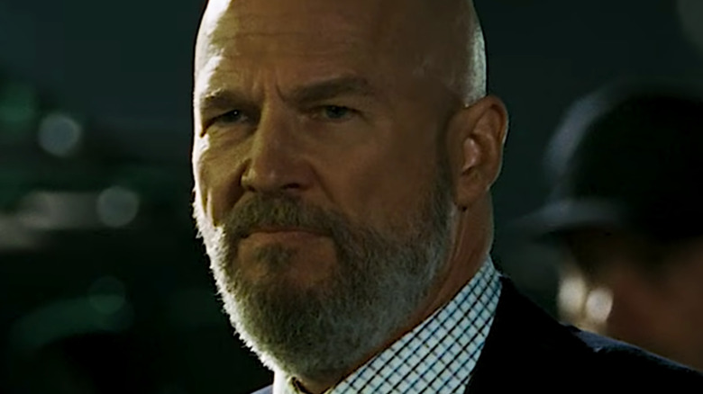Obadiah Stane in suit with stern face