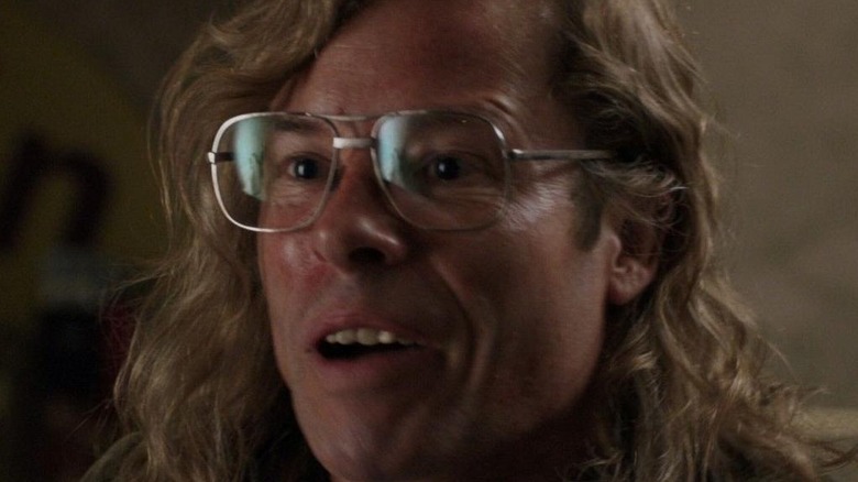 Younger Killian with glasses and long hair