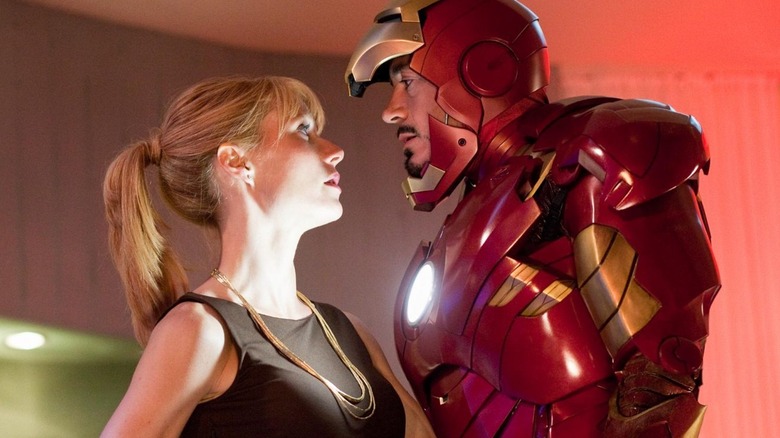 Pepper and Iron Man in suit standing close to each other
