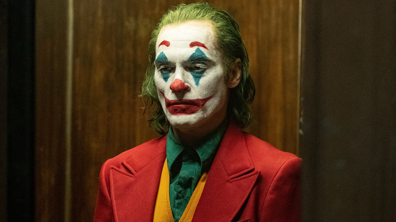 Joker standing in front of wood paneling (2019)