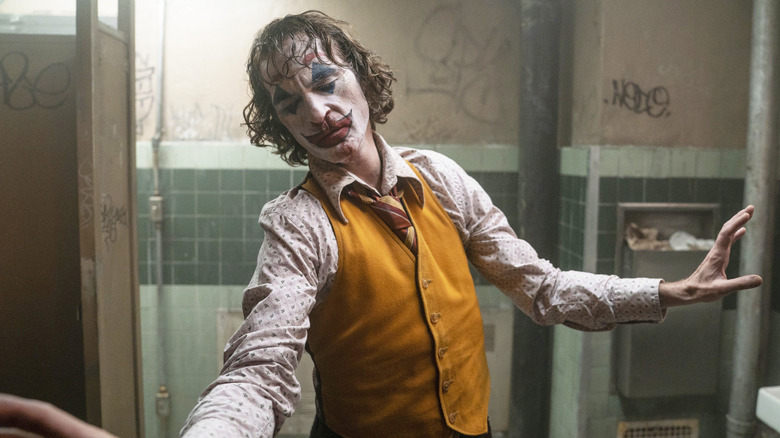 Arthur Fleck wearing Joker makeup in bathroom (2019)