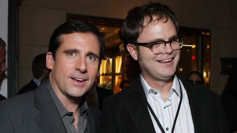 Steve Carell and Rainn Wilson smiling at a promotional event for "The Office"