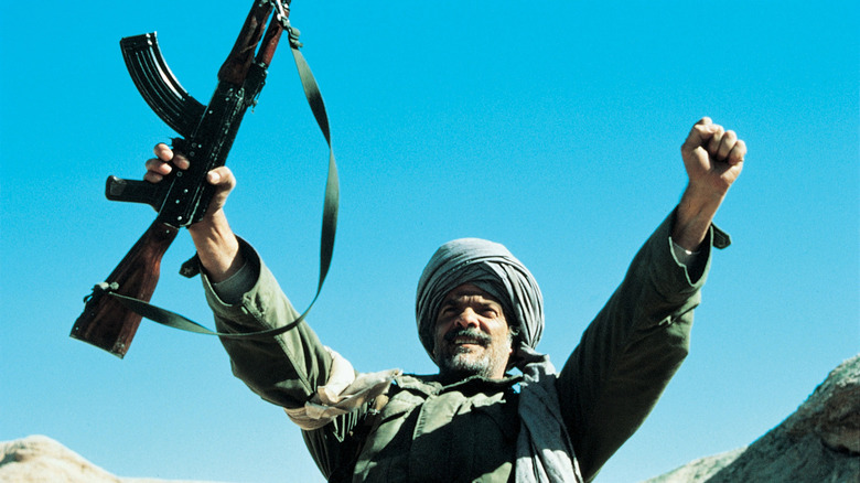 Masoud holds his hands up high in "Rambo III"