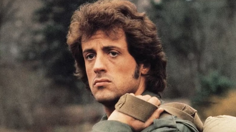 John Rambo looks forlorn carrying a backpack in First Blood (1982)