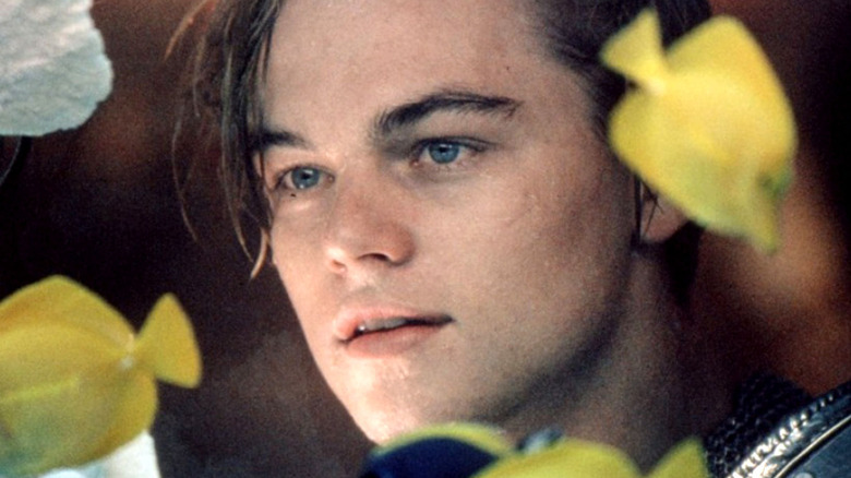 Leonardo DiCaprio in close-up, looking through a fish tank