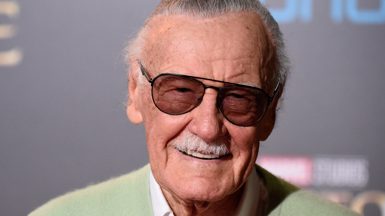 Stan Lee smiles on the red carpet