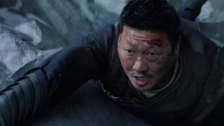 Benedict Wong climbing a mountain