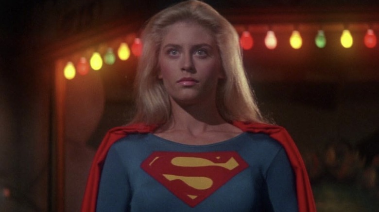 Supergirl stands in front of colored lights in "Supergirl" (1984)