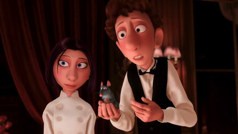 Linguini holding Remy while standing next to Colette