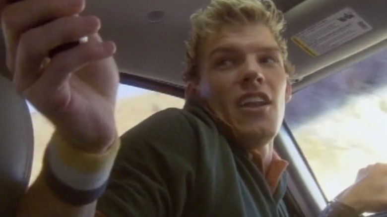 Mark turns around while sitting in the driver's seat of a car in The Butcher (2006)