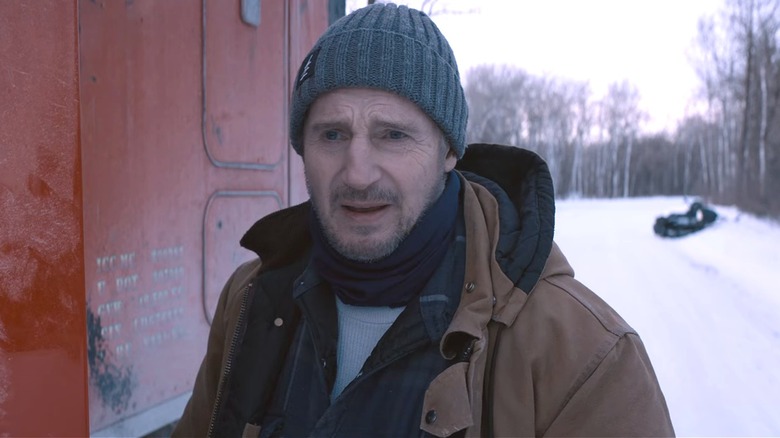 Liam Neeson gets out of his ice road truck 