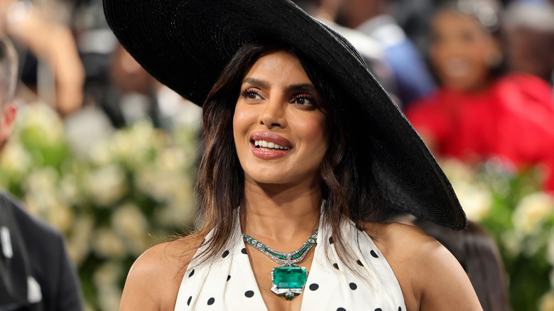 Priyanka Chopra Jonas wearing a giant hat on a red carpet