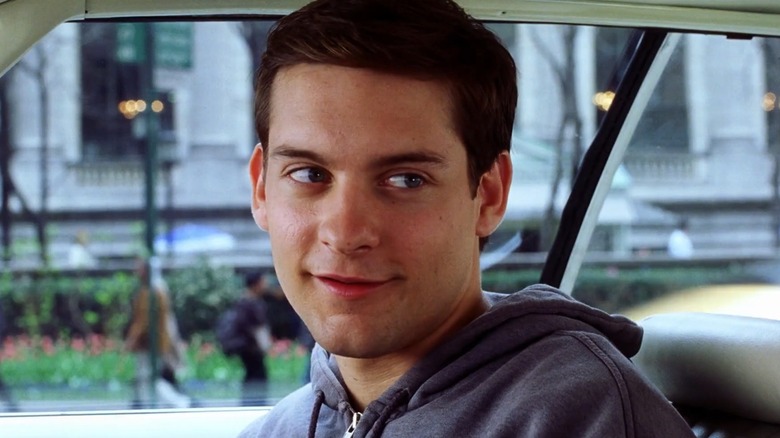 Peter Parker sitting gin a car in "Spider-Man"