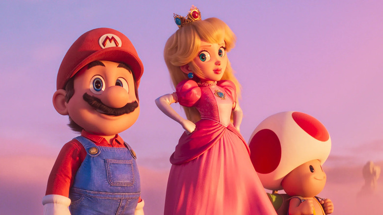 Mario standing next to Peach and Toad at sunset