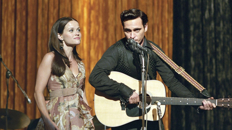 June Carter Cash and Johnny Cash singing on stage in I Walk The Line