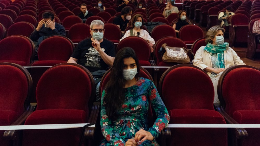 Patrons at a movie theater with social distancing