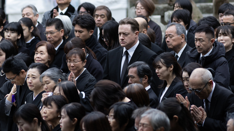 Philip standing in crowd at funeral