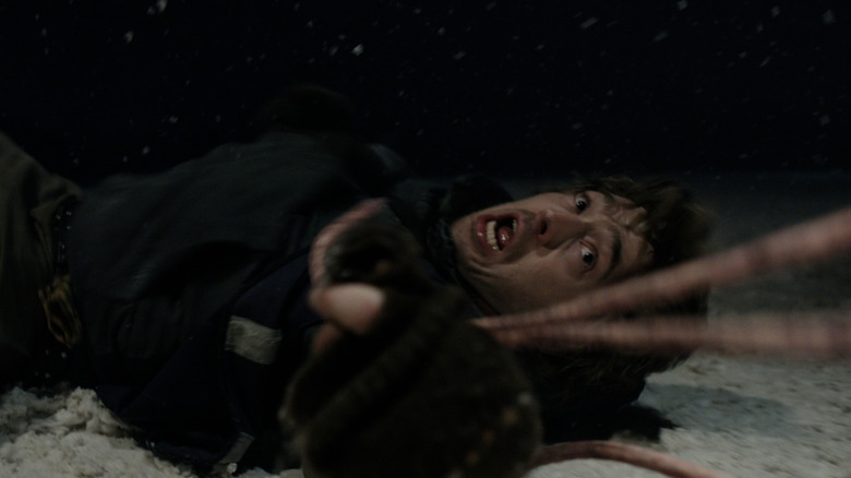 Tentacles grabbing a horrified Bryan in Resident Evil