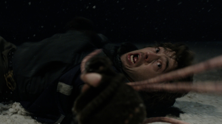 Tentacles grabbing a horrified Bryan in Resident Evil