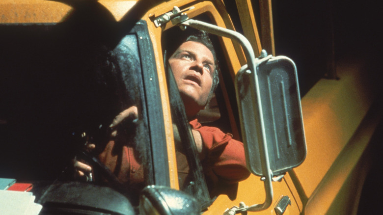 Roy Neary sitting in his truck looking up (1977)