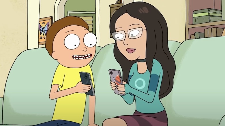 Morty and girlfriend holding phones on couch
