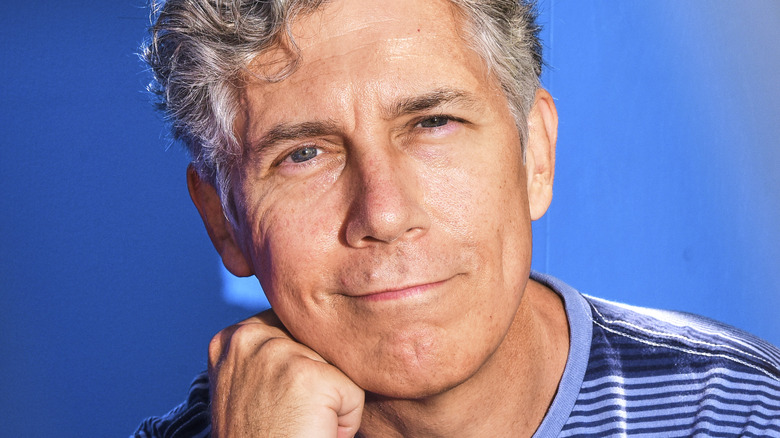 Chris Parnell smirking in a blue shirt