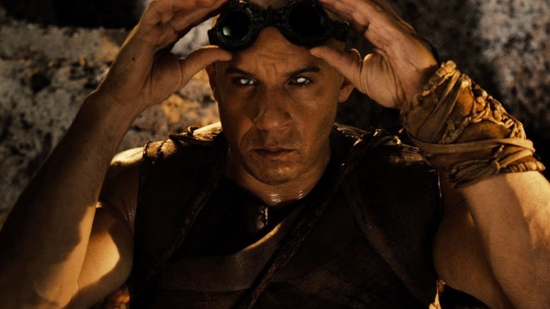 Riddick lifting his goggles